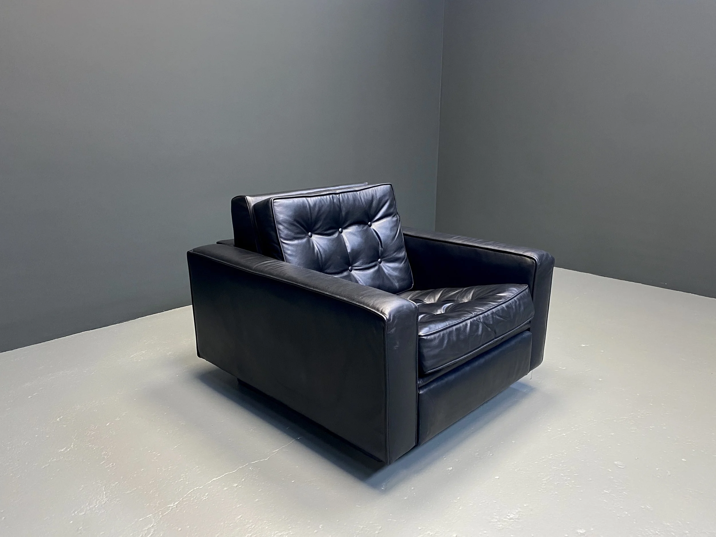 De Sede New York armchair and ottoman by Robert Haussmann in black tufted leather, 1950s