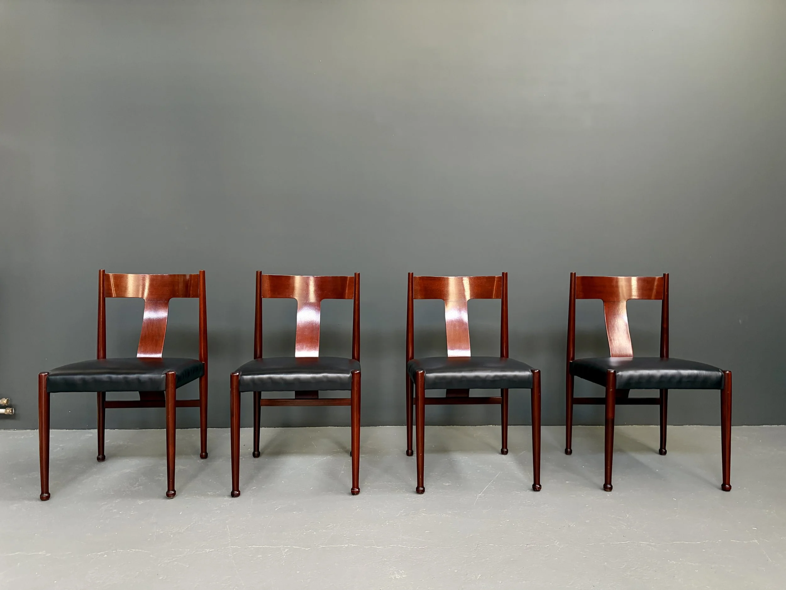 Set of four Italian red lacquered dining chairs with black skai seats and sculptural backs, 1970s