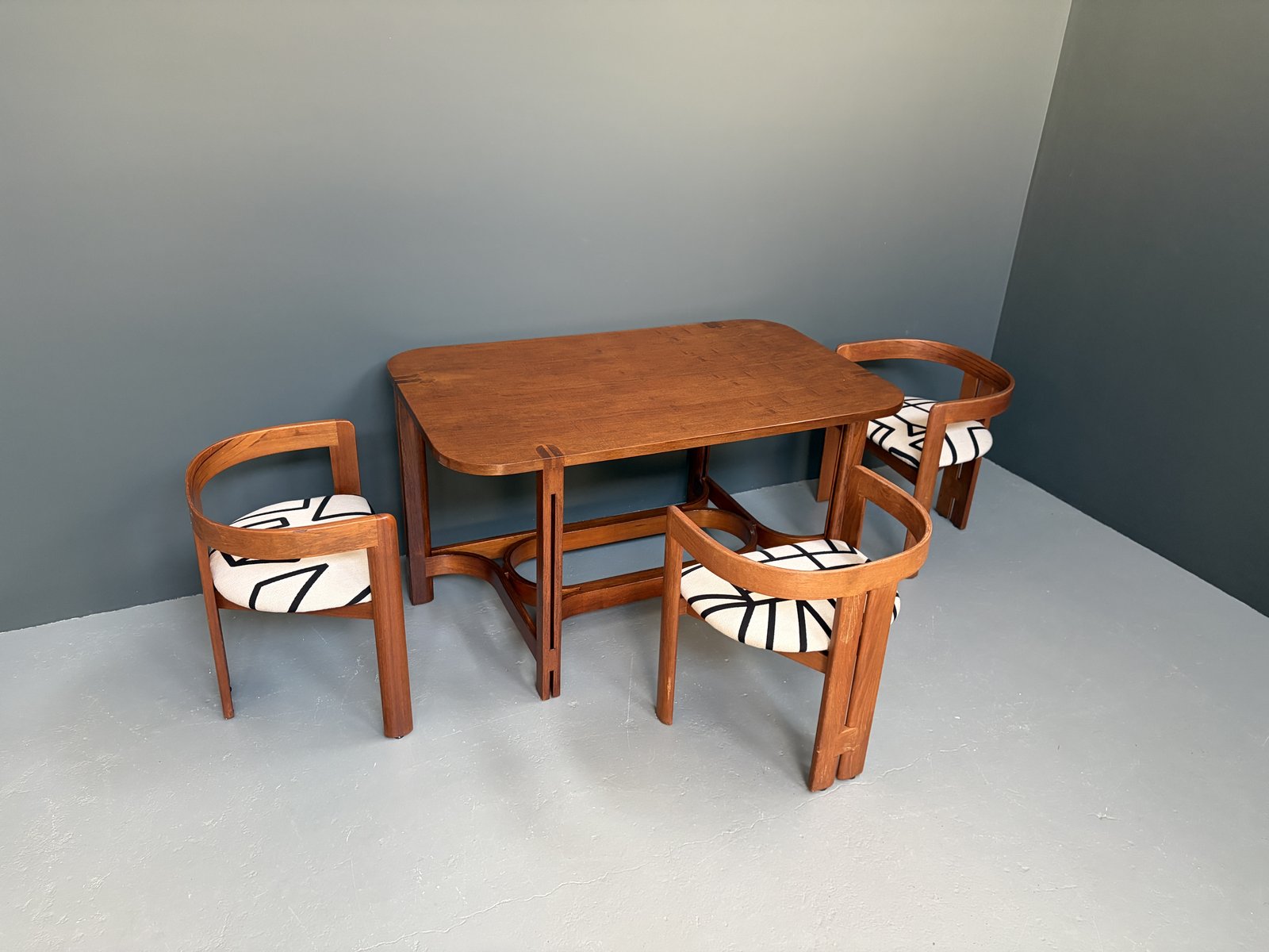 Italian teak Pigreco-style table in the manner of Tobia Scarpa, with pierced legs and exposed joinery