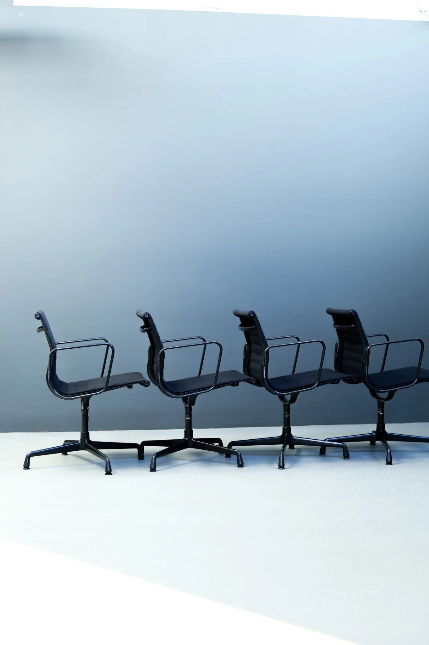 Set of four Eames Aluminum Group office chairs by Vitra in black aluminum and cotton upholstery