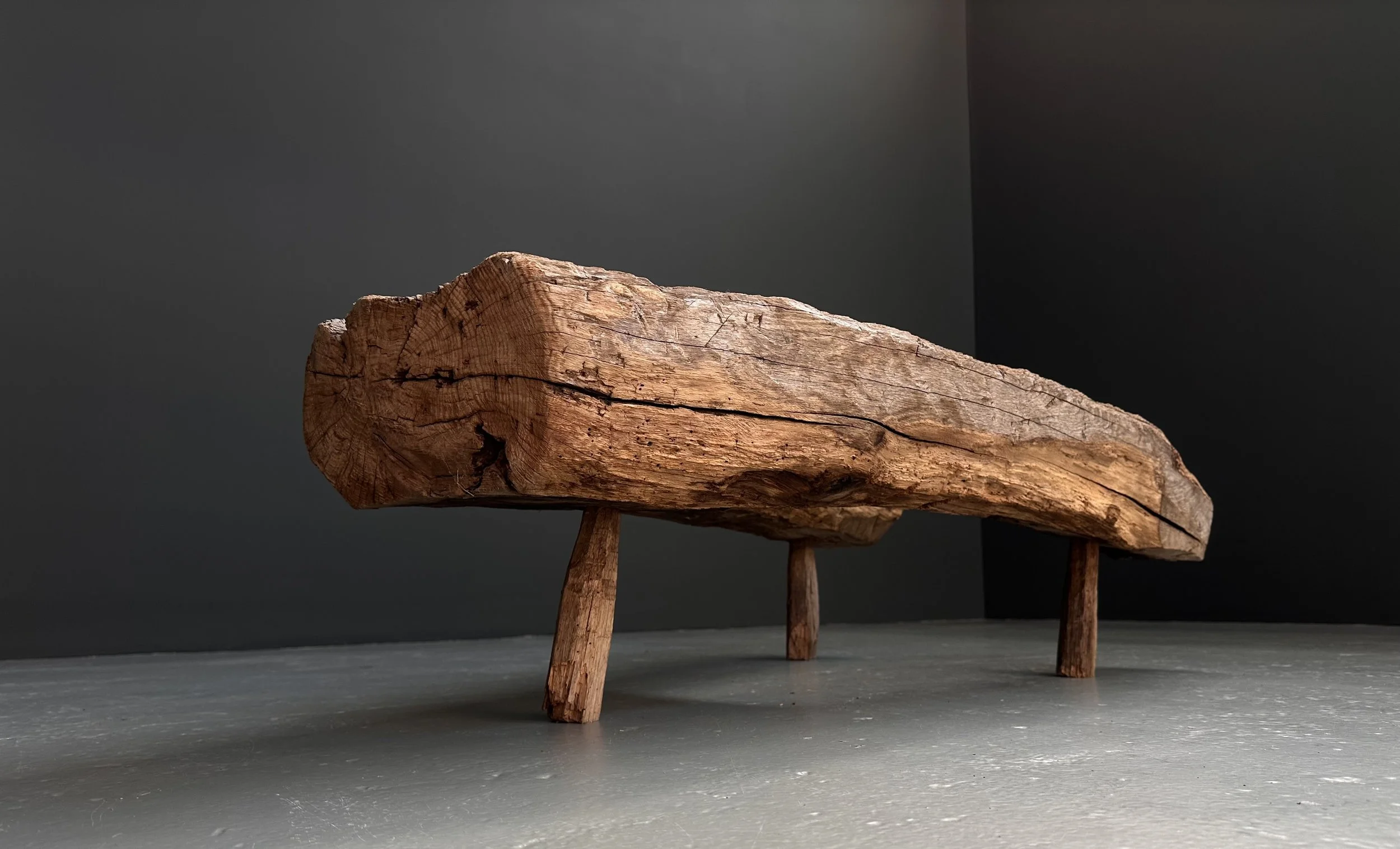 French primitive wood bench with weathered surface and organic forms, circa 1800, wabi-sabi aesthetic